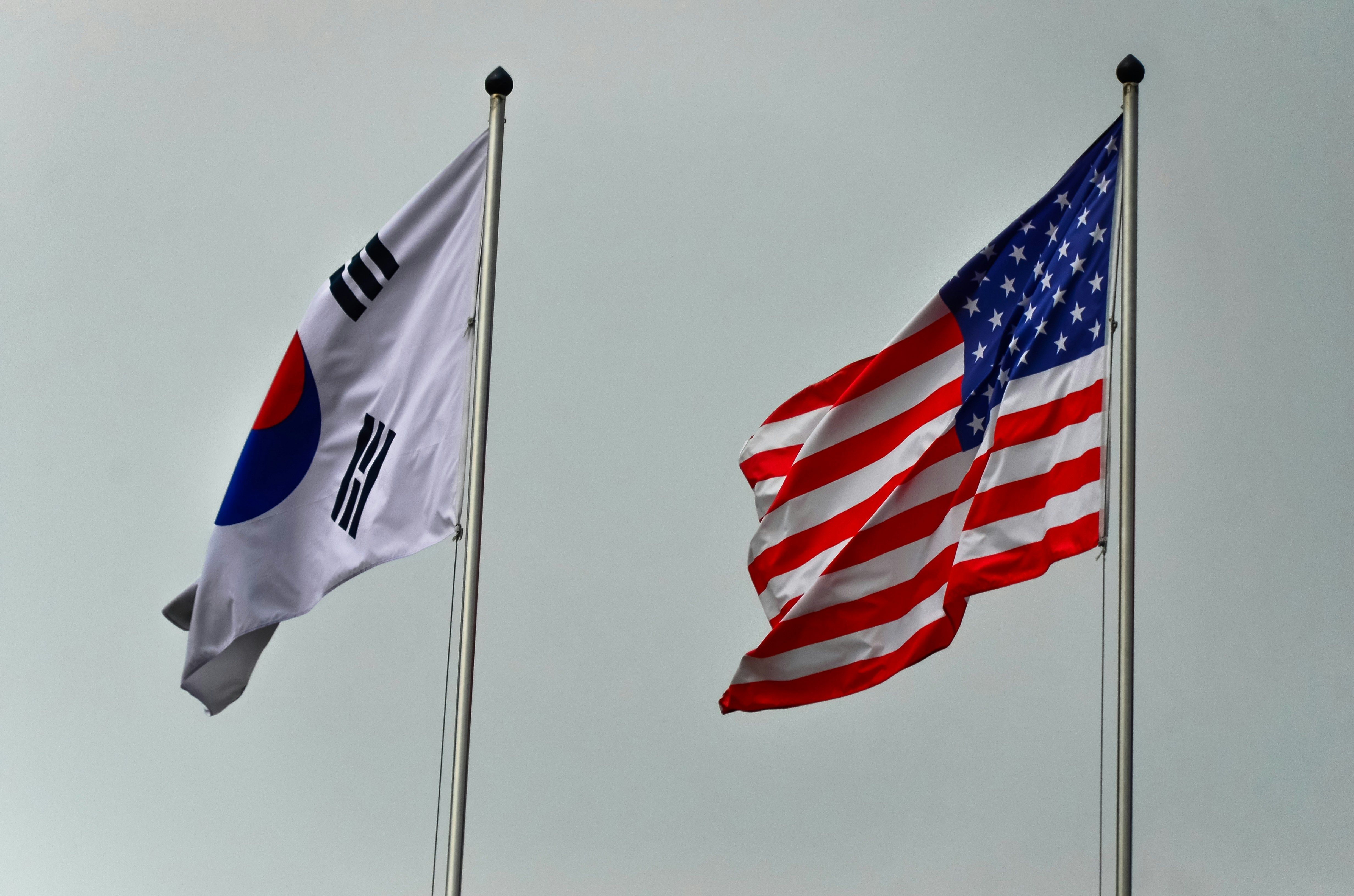 South Korean and United States flags waving in the wind.