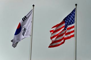 South Korean and United States flags waving in the wind.