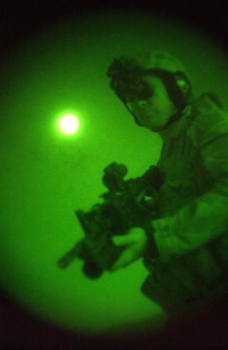Under an Afghan moon in 2005, an Australian Special Forces Task Group soldier conducts a night patrol