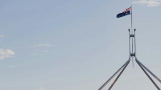 image of Australian flag flying over Parliament House