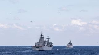 P-8I, P-8A and P-1 aircraft from Australia, the United States, Japan and India fly over HMAS Stalwart and INS Shivalik during Exercise Malabar 2022