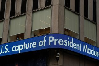 LED sign wrapped around a building corner, saying "U.S. capture of President Maduro"