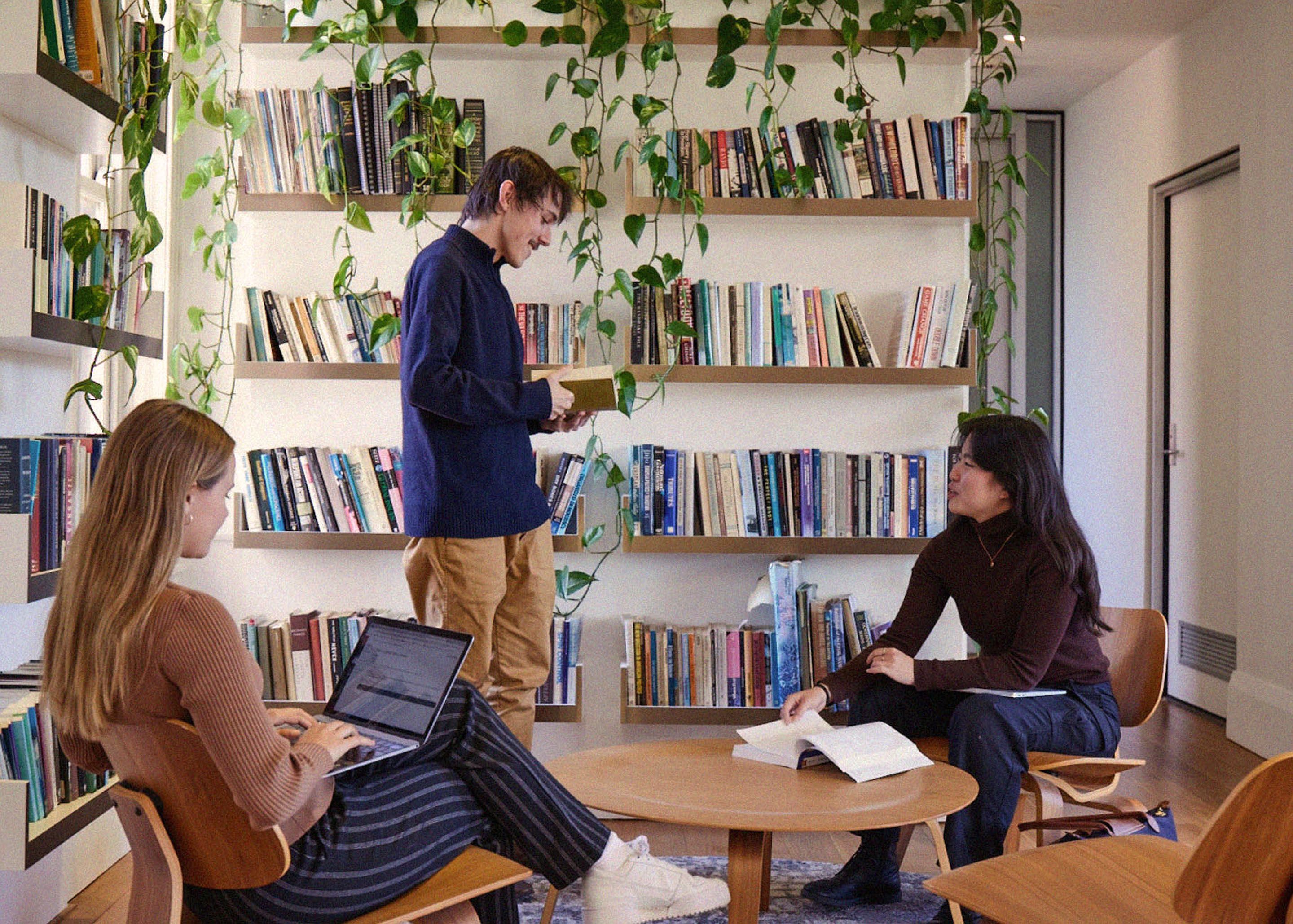 Three student interns reading and talking among themselves at the USSC's office.