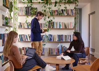 Three student interns reading and talking among themselves at the USSC's office.