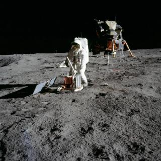Astronaut Buzz Aldrin deploying the solar panels of the passive seismic experiment package during the Apollo 11 Mission