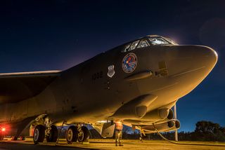 A US Air Force crew chief helps prepare a B-52H Stratofortress for takeoff during training operations at Royal Australian Air Force Base