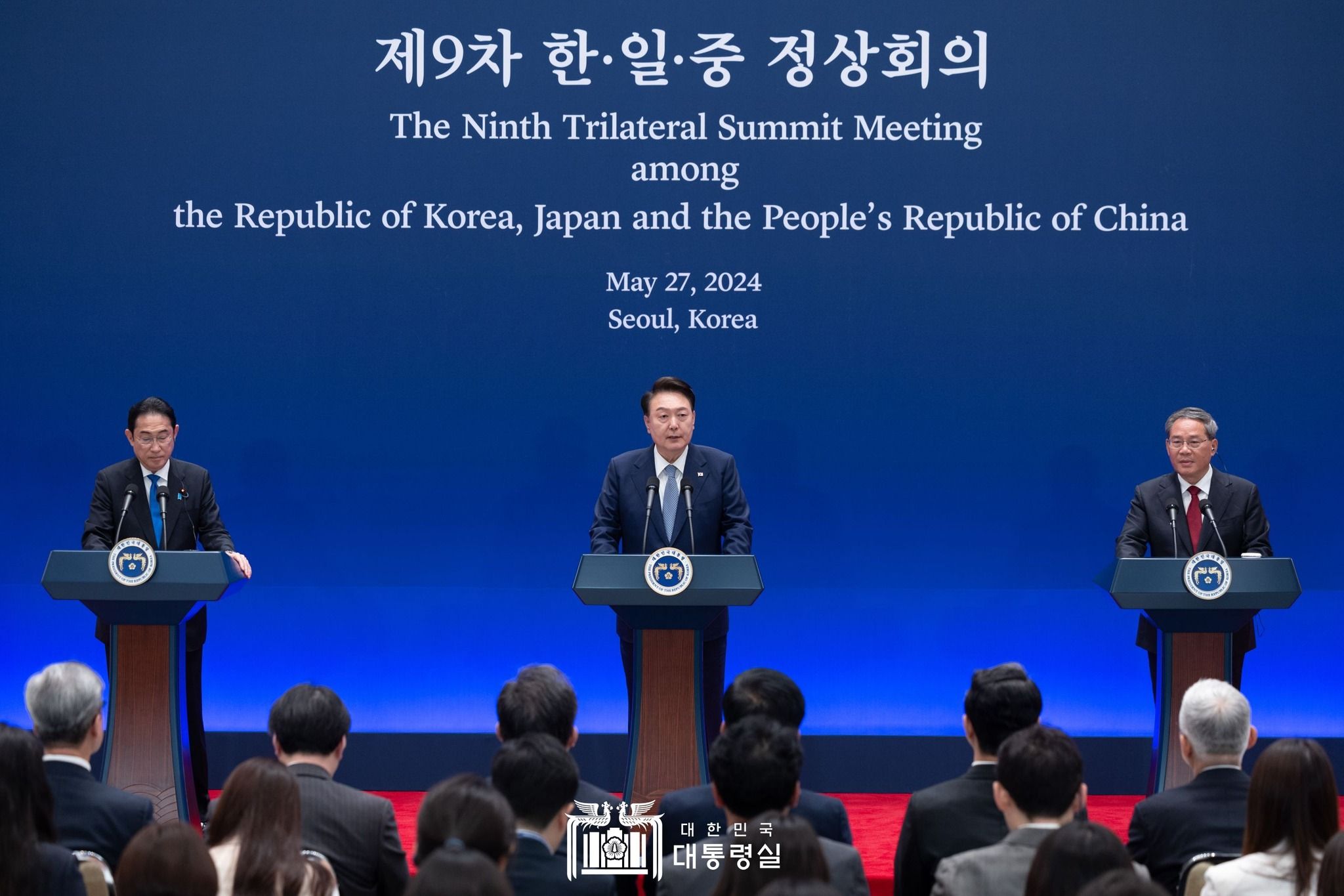 Three leaders from South Korea, China and Japan speaking at the Ninth Trilateral Summit Meeting in 2024