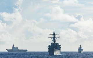 Japan Maritime Self-Defense Force Hyuga-class helicopter destroyer JS Hyuga, US Arleigh Burke-class destroyer USS Fitzgerald and Indian Navy Shivalik-class frigate INS Sahyadri conduct a surface warfare exercise off the coast of Guam during Exercise MALABAR 25.