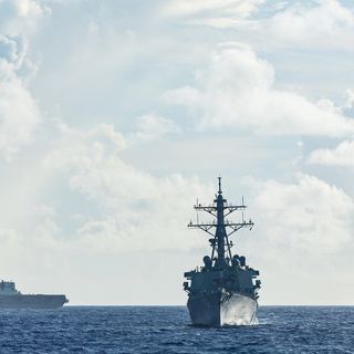 Japan Maritime Self-Defense Force Hyuga-class helicopter destroyer JS Hyuga, US Arleigh Burke-class destroyer USS Fitzgerald and Indian Navy Shivalik-class frigate INS Sahyadri conduct a surface warfare exercise off the coast of Guam during Exercise MALABAR 25.