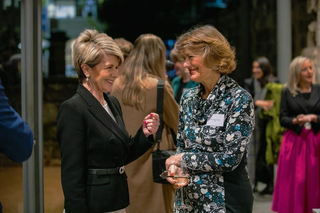Two people talking at an event.