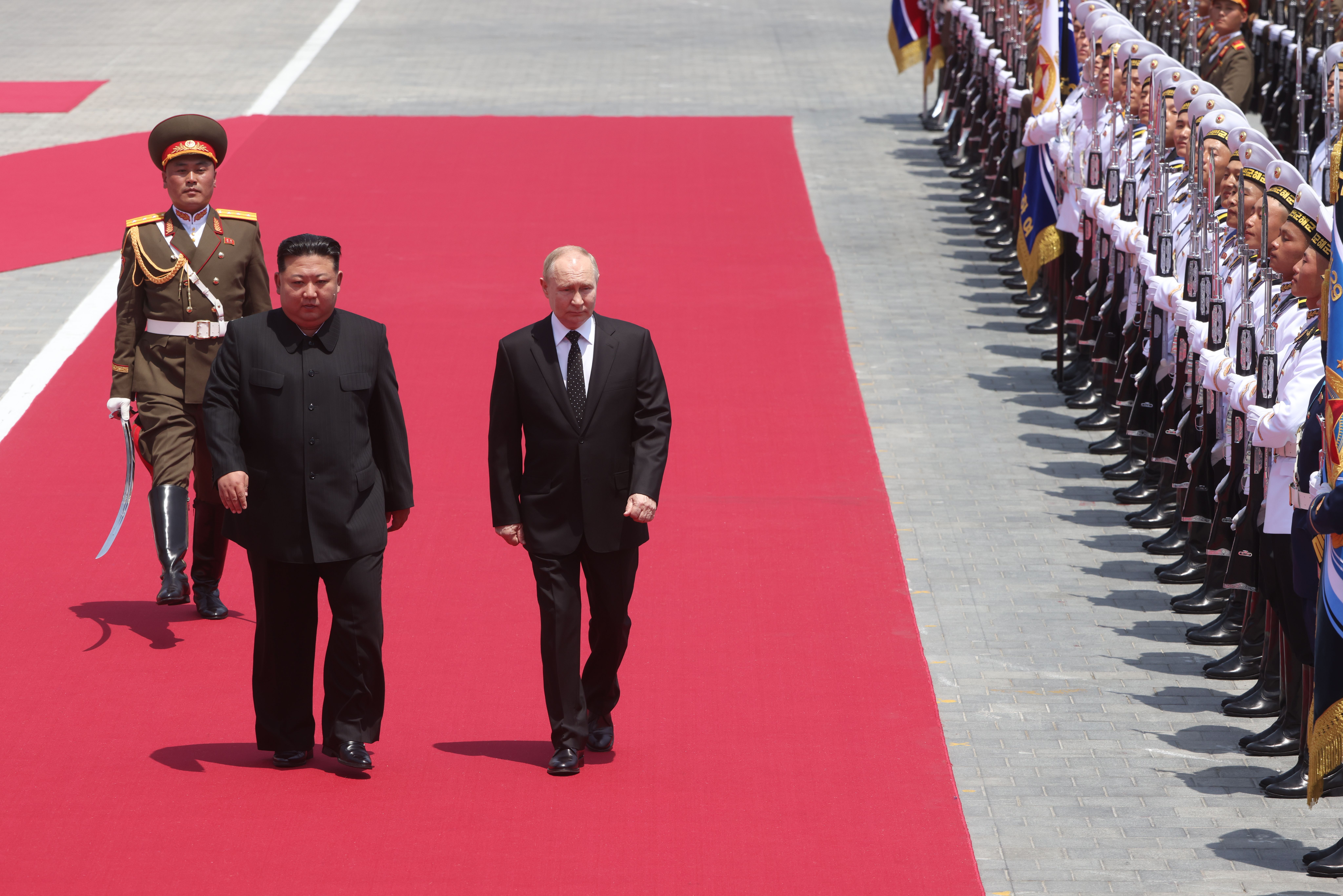  Russia's President Putin (R) and North Korean Supreme Leader Kim Jong Un  (L) attend a welcoming ceremony,  June 19, 2024, in Pyongyang, North Korea