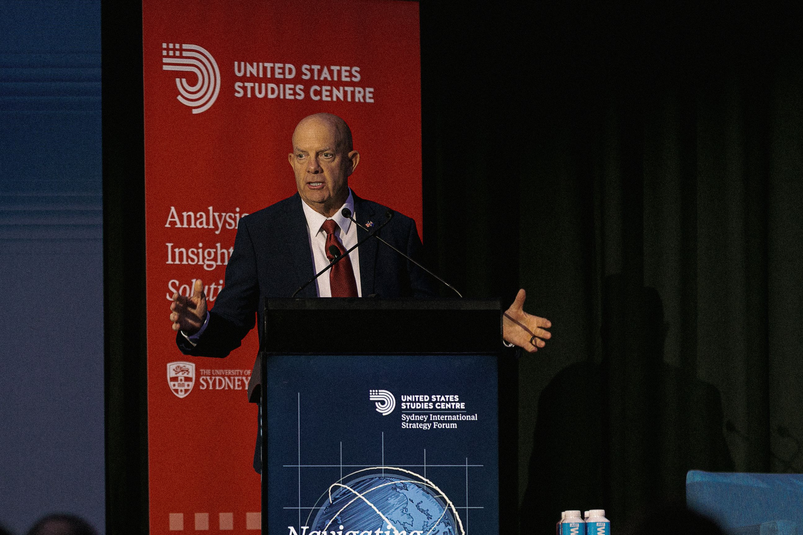General Berger speaking on stage at the conference lectern.