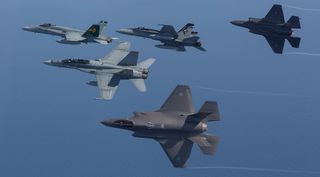 F-35A Joint Strike Fighters fly in formation with F/A18 Hornets