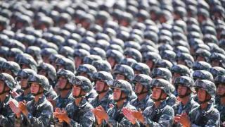 Chinese soldiers applaud during a military parade