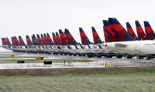 Planes belonging to Delta Air Lines sit idle at Kansas City International Airport on April 3, 2020