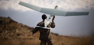 A US Marine Corps sergeant prepares to launch a Small Unmanned Aircraft System