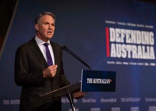 Person speaking at a lectern