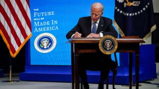 President Joe Biden signs an executive order related to American manufacturing at the White House, 25 January 2021 (Getty)