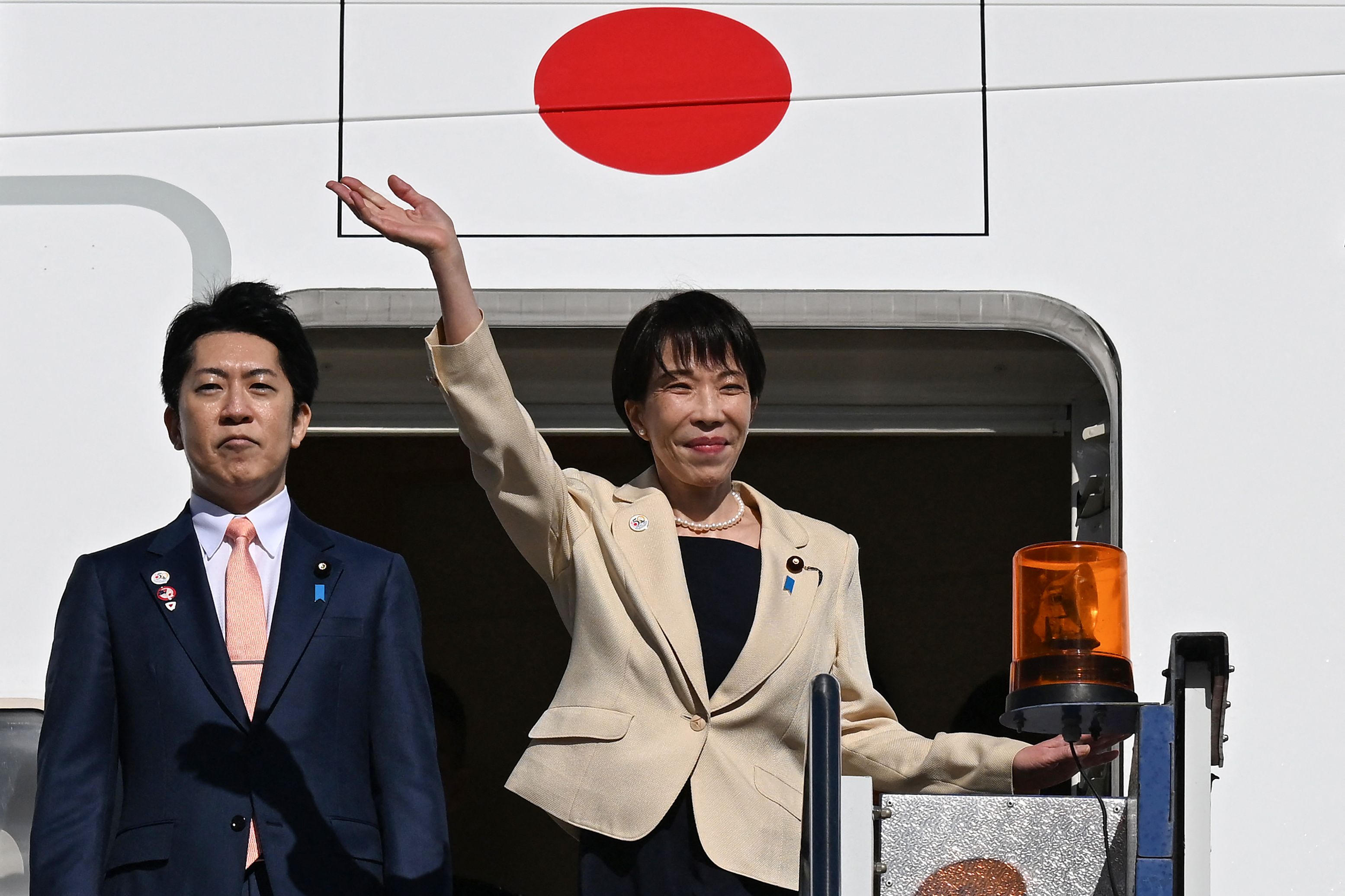 Japan's Prime Minister Sanae Takaichi waves as she departs from a RAAF base in Canberra on May 5, 2026, after a three-day official visit to Australia.