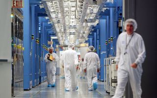 People walk around a computer server facility.