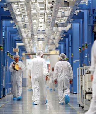 People walk around a computer server facility.