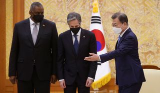 South Korean President Moon Jae-in greets US Secretary of Defense Lloyd Austin and US Secretary of State Antony Blinken during their meeting at the Presidential Blue House on 18 March 2021 in Seoul (Getty)