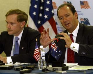 Australian Trade Minister Mark Vaile (R) addresses a press conference with US Trade Representative Robert Zoellick (L) 08 February 2004 in Washington, DC, where they announced the two countries had reached an "historic" free trade agreement. Negotiators exhausted by two weeks of top-level round the clock talks, concluded the tariff-busting pact after a telephone call between Australian Prime Minister John Howard and US President George W. Bush 08 February 2004