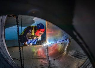 Construction workers at the round billet continuous caster site of the Maanshan Iron & Steel Company new special steel phase II project, Anhui Province of China, October 2026.