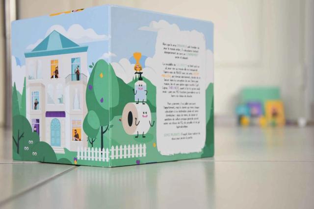 Boîte du jeu Confin'it illustrée d'un immeuble et de ses habitants