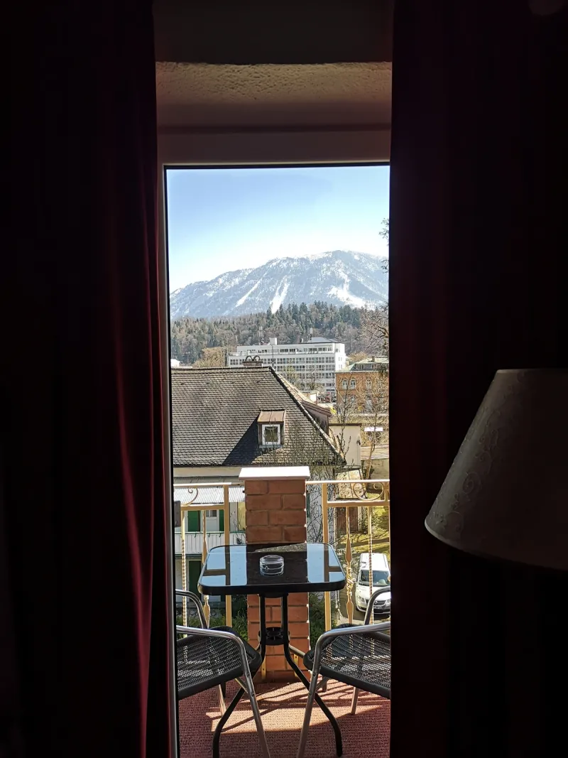 Panoramic view from Hotel Almrausch balcony over the rooftops of Bad Reichenhall with Alpine panorama