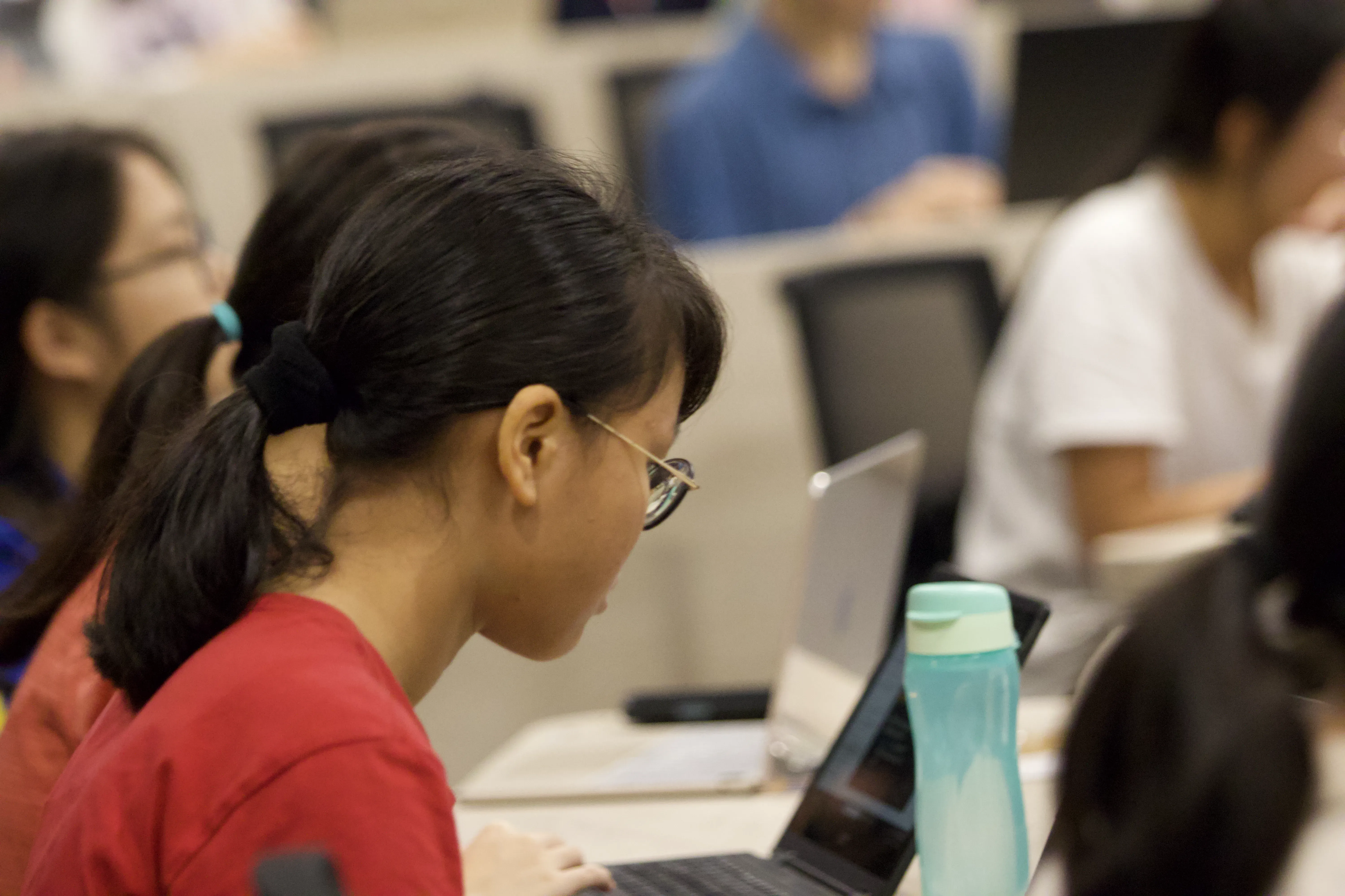 Student focused on laptop screen during hands-on coding session at BuildingBlocs workshop