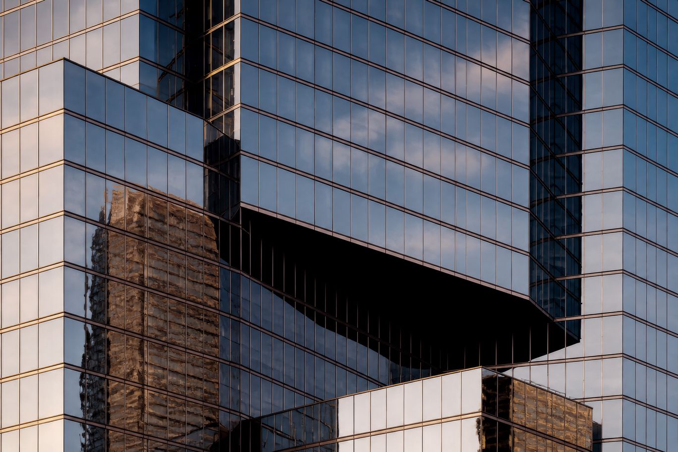 Glass office towers reflecting the sky