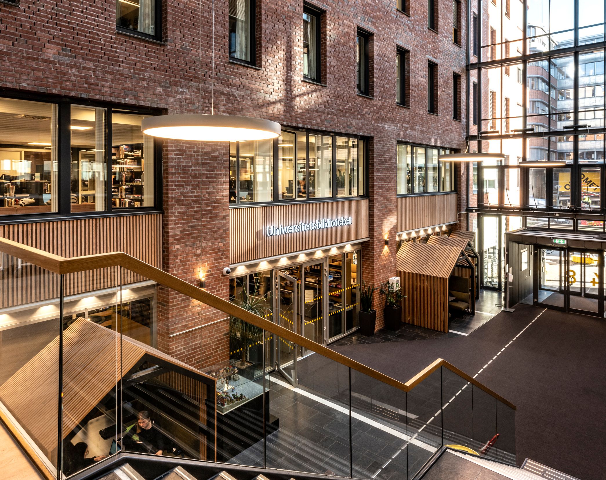 a large brick building with a glass roof and stairs