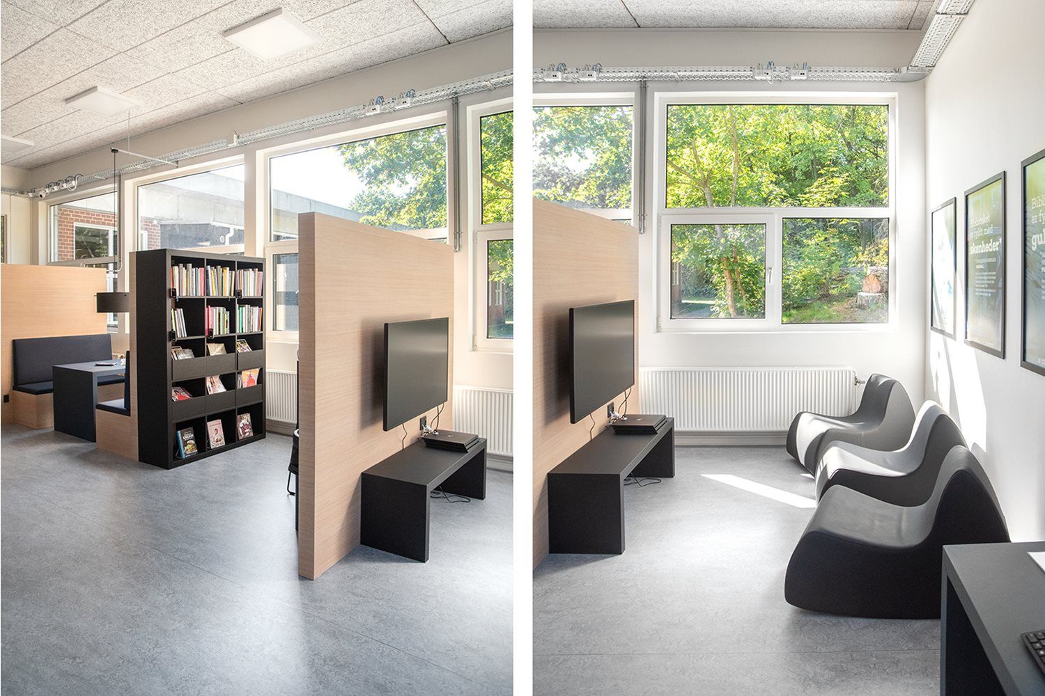 A bright, modern common area divided by a wooden partition, featuring a study booth, bookshelf, and wall-mounted TVs opposite wavy lounge chairs by large windows.