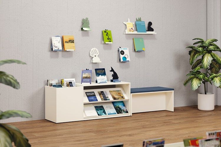 Modern reading room with books on wall shelves and a low bookshelf, a bench, and a potted plant.