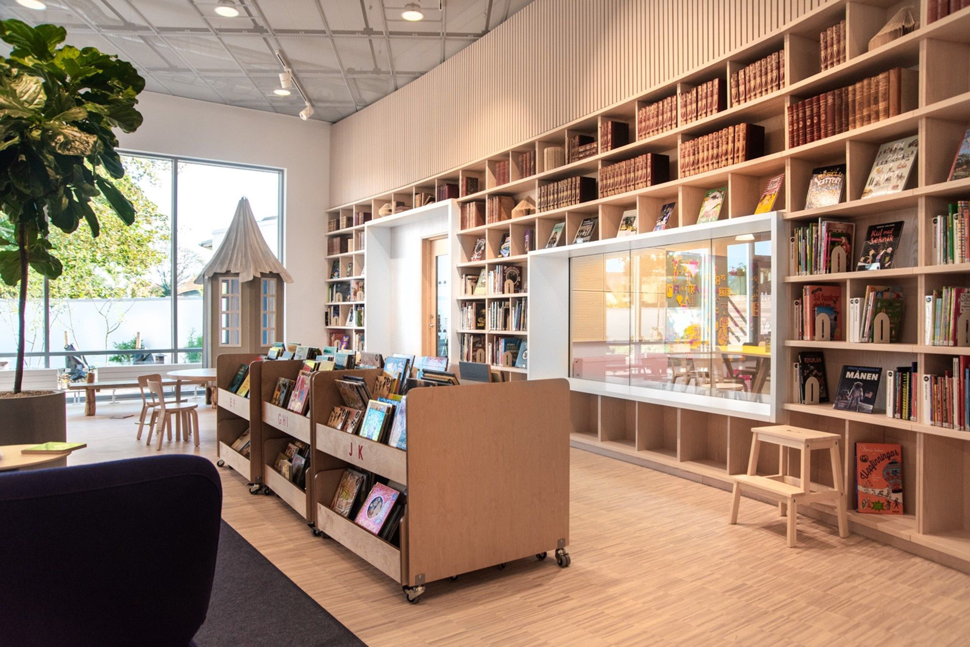 et bibliotek med bokkasser og mange bokreoler langs vegg