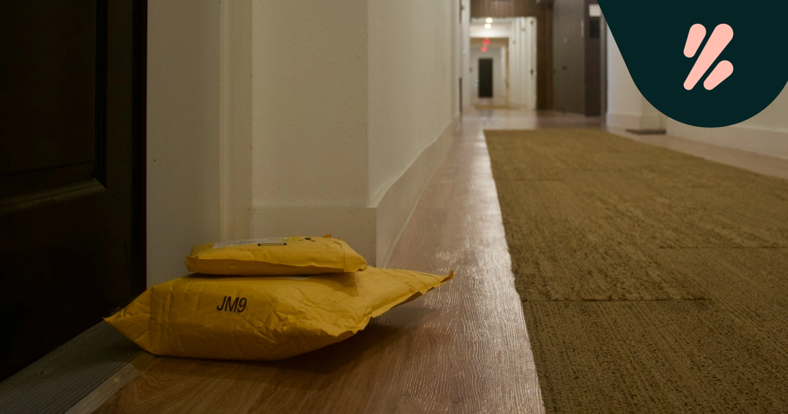 Parcels left on the floor of a hallway, outside an apartment's front door. 