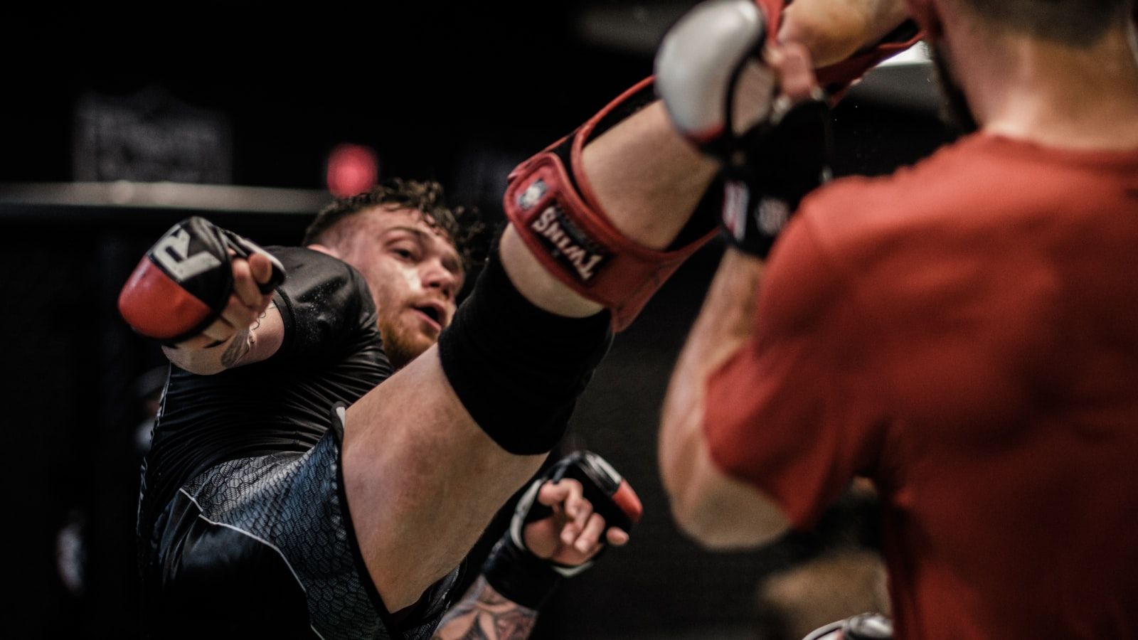 A mixed martial artist throwing a punch in the cage