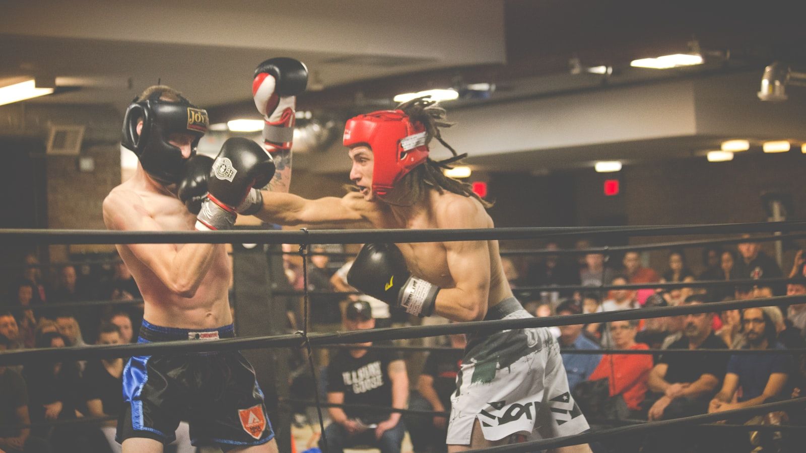 Two fighters facing off inside the octagon