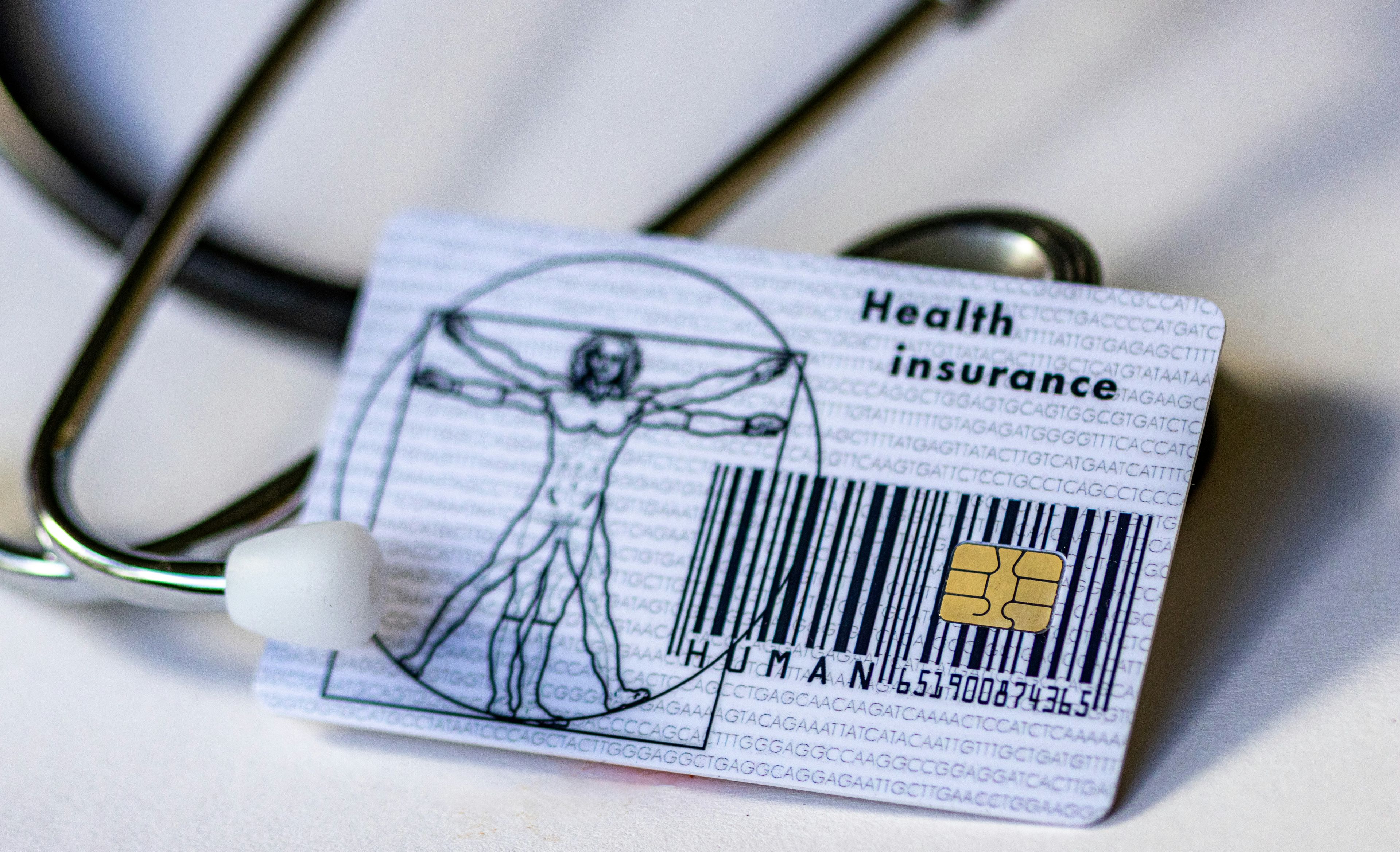 a health insurance card with a bar code and a stethoscope .