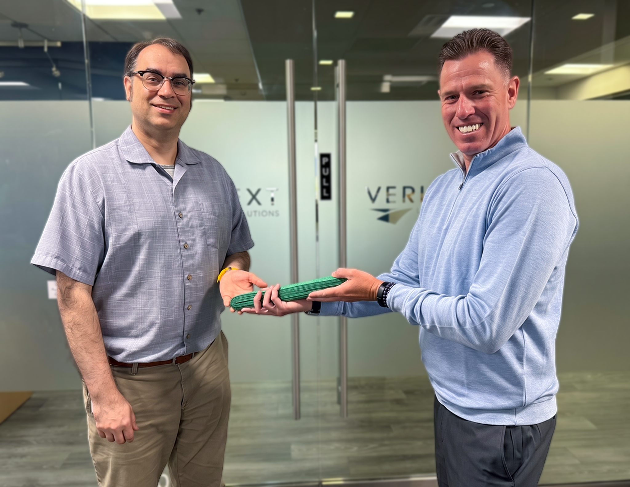 A Veritext Employee being awarded his green belt.