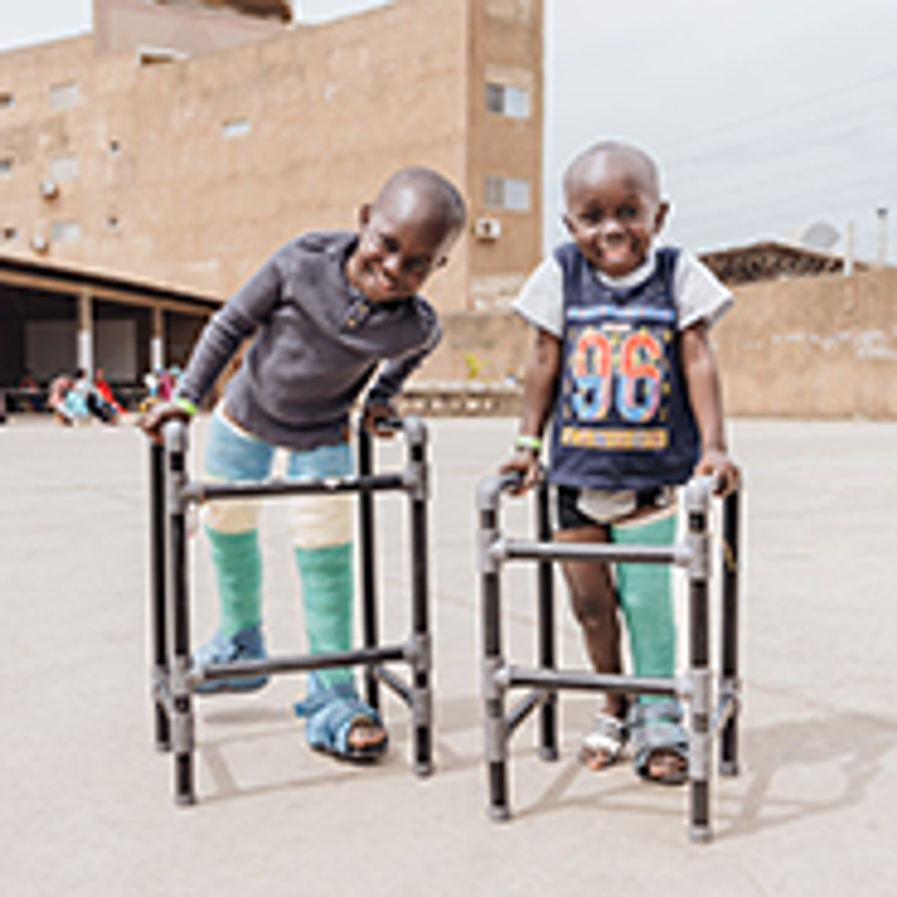 Small image of two boys with casts and walkers
