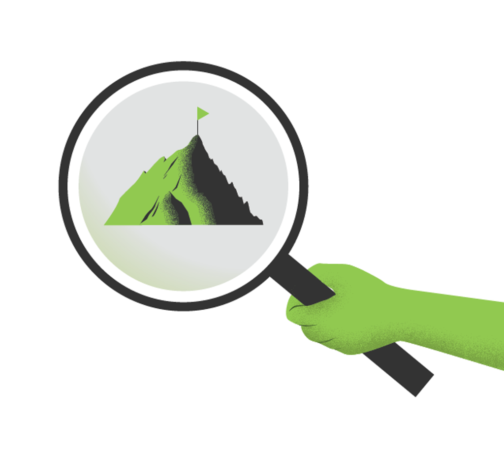 Hand holding a magnifying glass showing a mountain with a flag in the distance