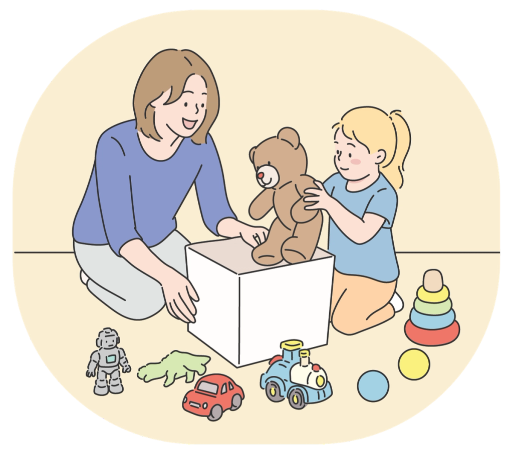 Mom helping a little girl pack a teddy bear in a box to donate