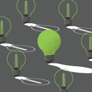 Several unlit light bulbs with one lit lightbulb