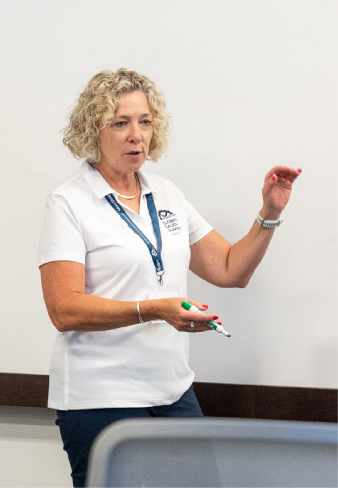 A MoreSteam facilitator explaining the paper airplane exercise to a class