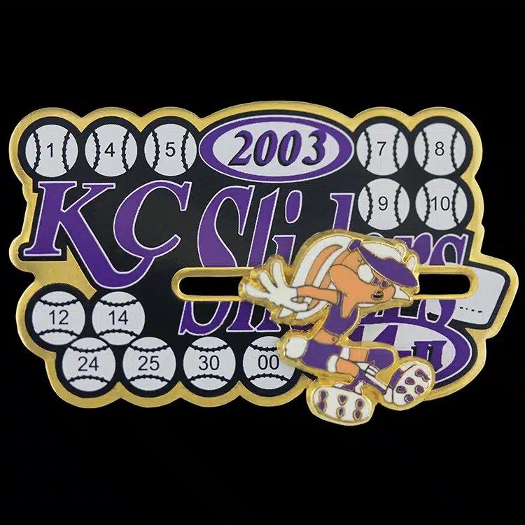 Purple and gold die struck lapel pin shaped like a baseball scoreboard, an example of Patchworks USA's custom pin work.