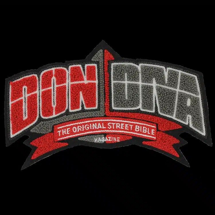 Chenille DON DNA patch in red and grey tufted letters with a red embroidered banner reading The Original Street Bible, on black felt.