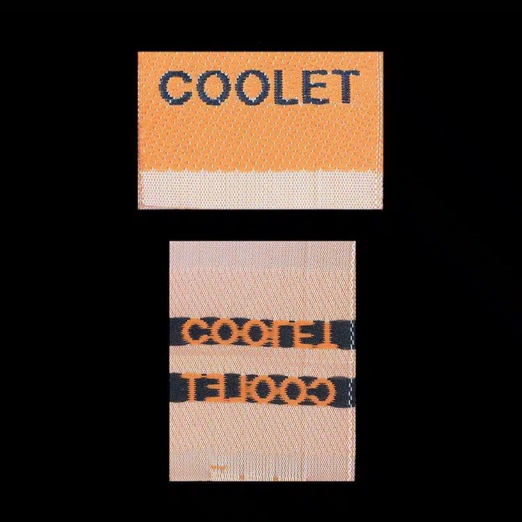 Coolet woven labels, front and back, Manhattan cut fold, orange lettering on peach.