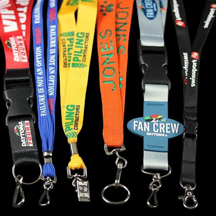 Bundle of printed and woven lanyards in red, blue, orange, yellow and black with clips and breakaways